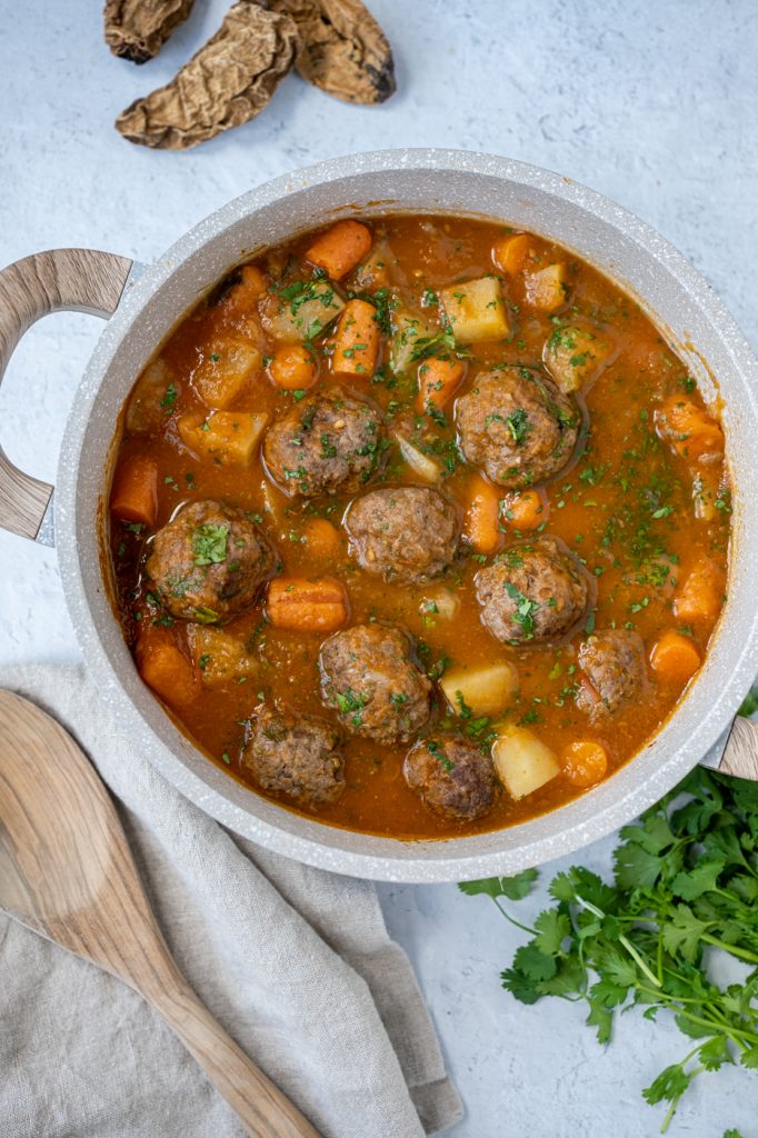 Pan of albondigas (meatballs) with potatoes, carrots in a chipotle sauce.